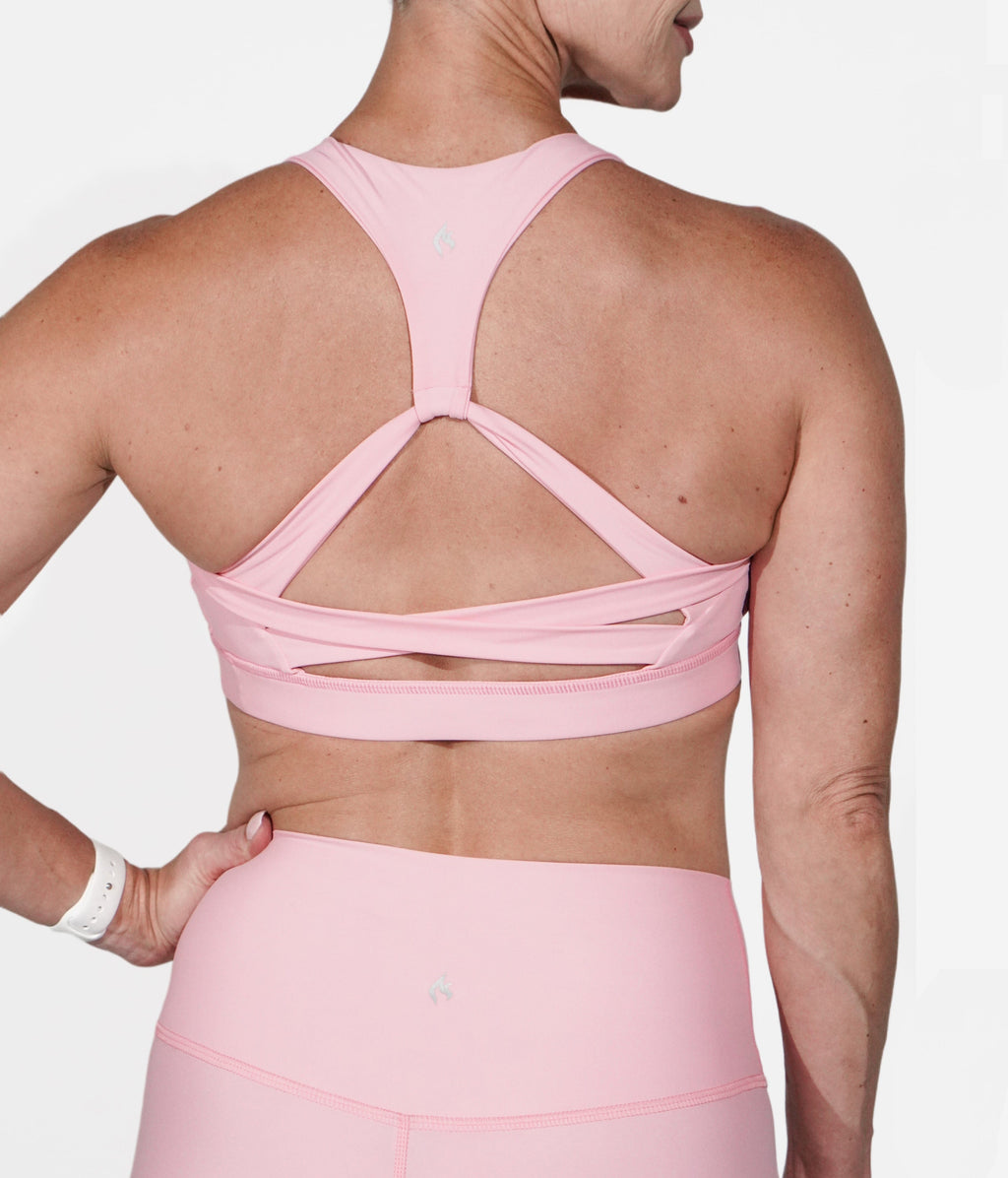 A woman wearing the Goddess Pink Bra from NoorFit.