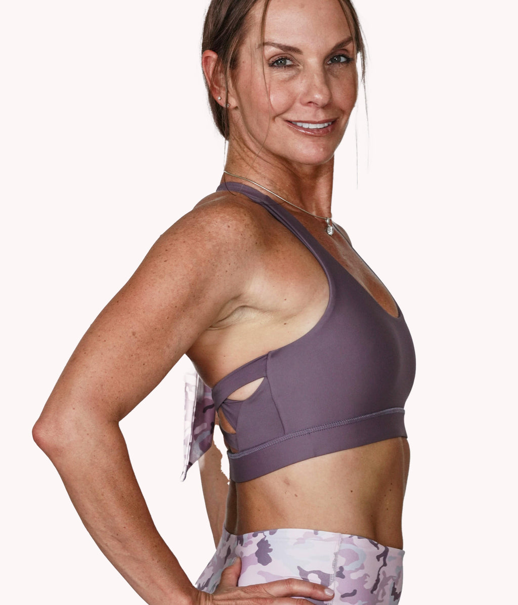 A woman wearing the Mulberry Bra with a racerback design from NoorFit.