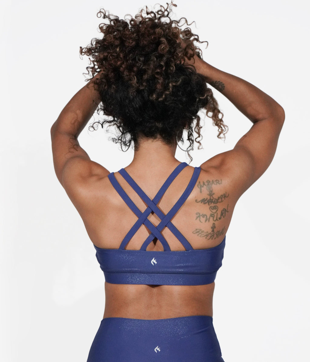 A model with red hair wearing the Galaxy Strappy Back Bra.