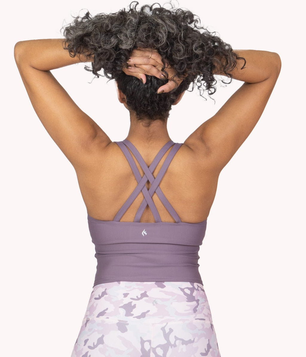 A plus-size woman wearing the Mulberry Crop Top Tank from NoorFit.