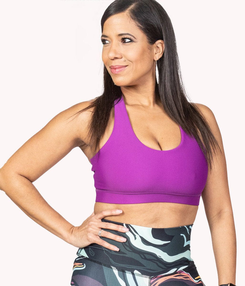 A woman wearing the Pink Saffron Bra from NoorFit.