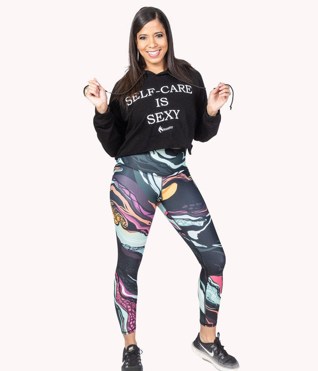 Image of a woman wearing the Self-Care Is Sexy Crop Hoodie from NoorFit.