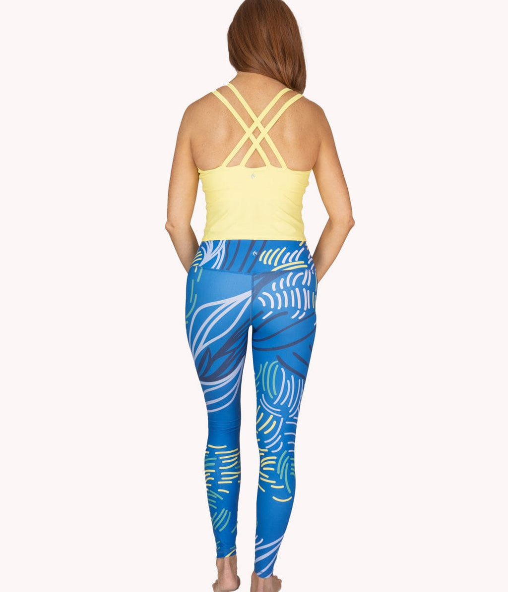 A woman wearing the Daybreak Crop Tank from NoorFit.