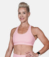 A woman wearing the Goddess Pink Bra from NoorFit.
