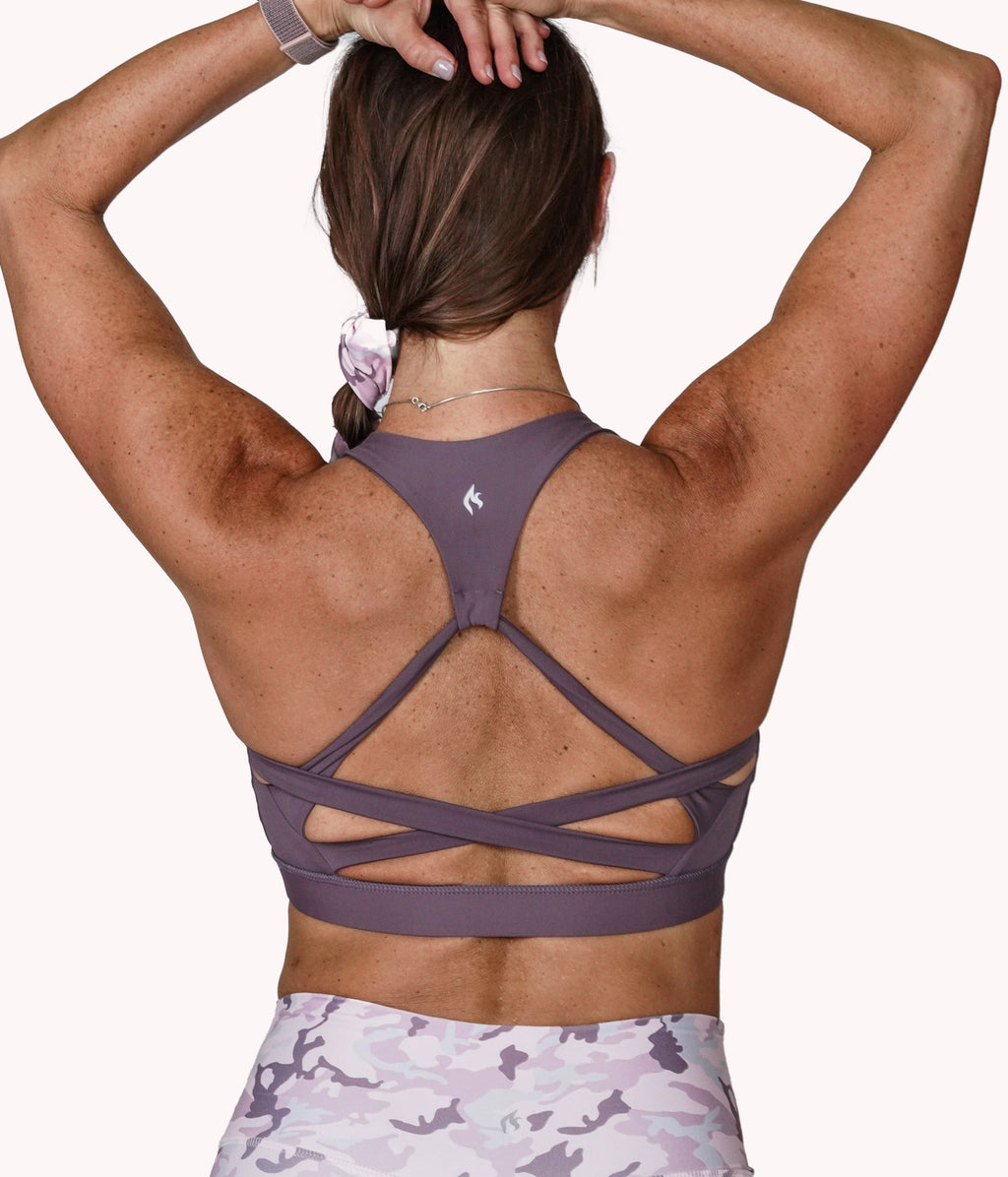 A woman wearing the Mulberry Bra with a racerback design from NoorFit.