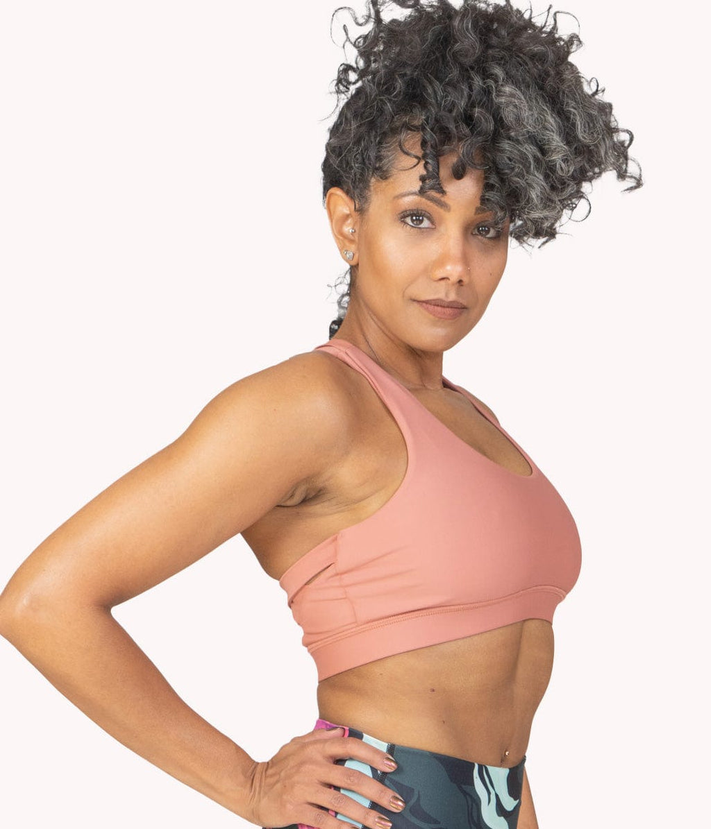 A woman wearing the Bronze Spice Bra from NoorFit.