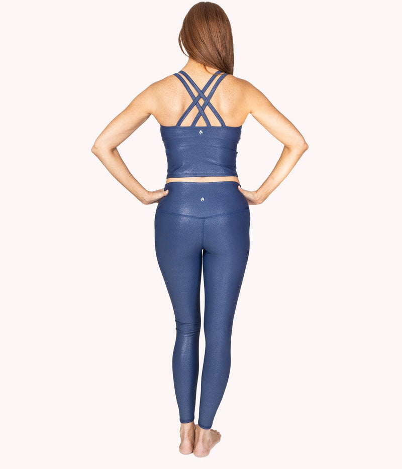 A model showing the back design of the Galaxy crop tank along with the matching pair of leggings. 
