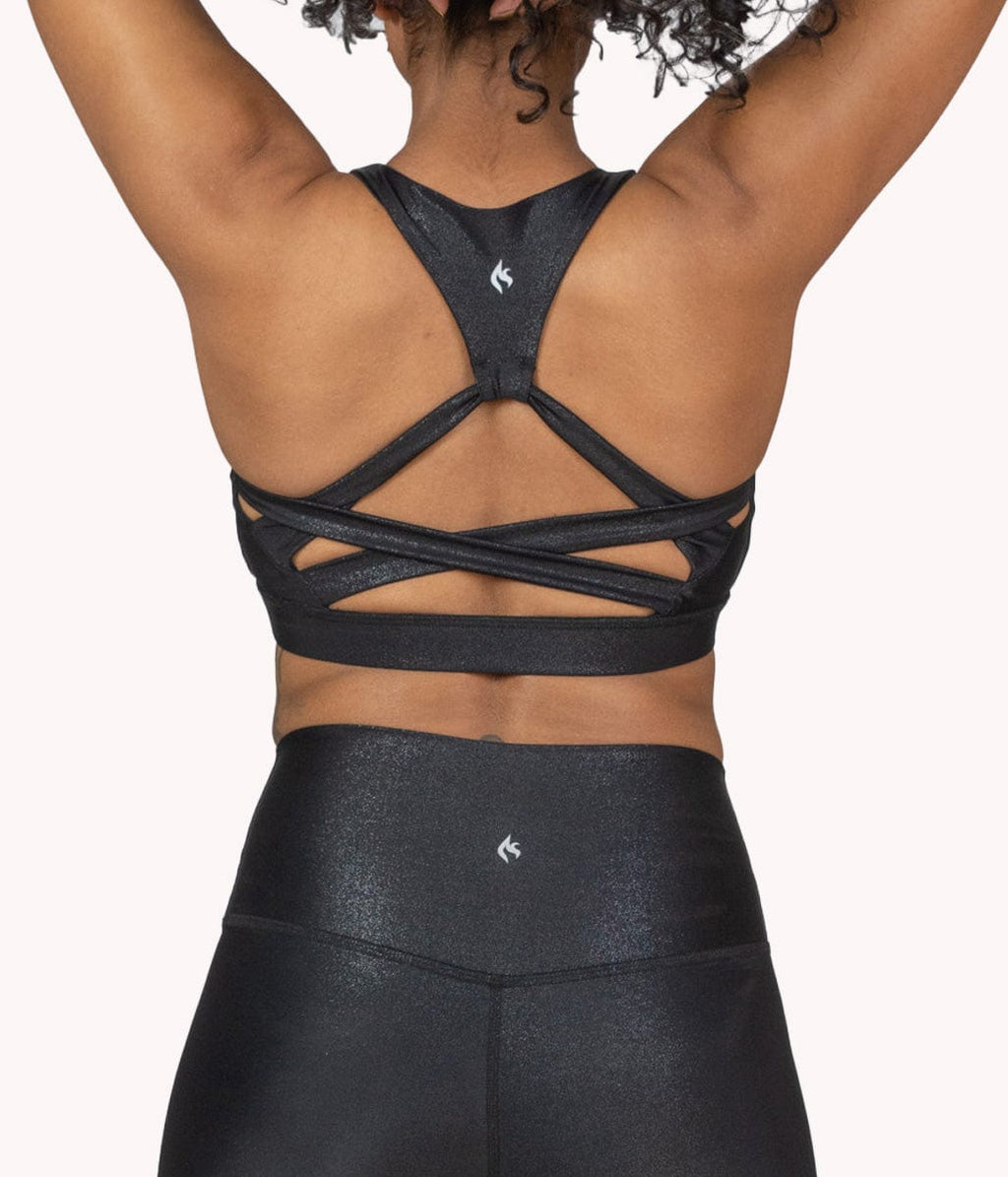 A model showing the racerback design of this sports bra. 