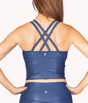 A model showing the Criss Cross Strappy Back design of this crop tank.