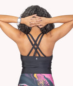 A model showing the Criss Cross Strappy Back design of the crop tank.