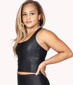 Image of a woman wearing the Showstopper Crop Tank from NoorFit. Description 