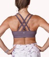 Image of a woman wearing the Mulberry Bra (strappy) from NoorFit.